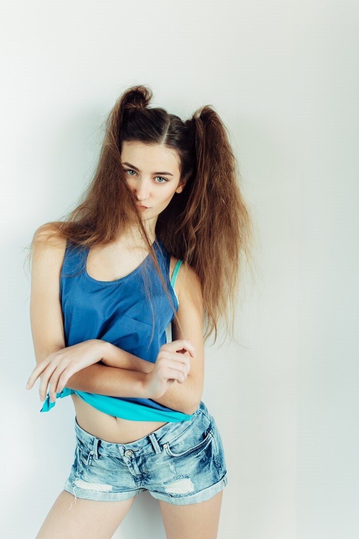 20250117235911-4810435b9c4b-young-beautiful-woman-posing-white-wall_1153-6585.jpg