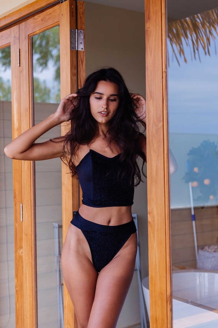 20250129155444-99e08477fd18-caucasian-fit-tanned-woman-wearing-vintage-old-bikini-posing-luxury-hotel-villa_343596-1250.jpg